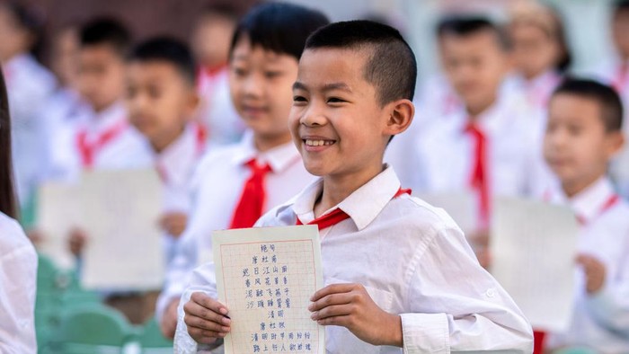 HOHHOT, CHINA - JUNE 13: A student shows his handwriting work during a calligraphy competition at a primary school on June 13, 2022 in Hohhot, Inner Mongolia Autonomous Region of China. (Photo by Ding Genhou/VCG via Getty Images