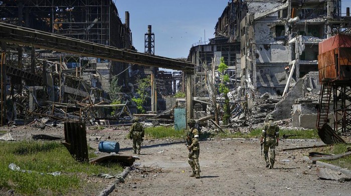 Russian soldiers walk through the debris of the Metallurgical Combine Azovstal, in Mariupol, on the territory which is under the Government of the Donetsk Peoples Republic control, eastern Ukraine, Monday, June 13, 2022. The plant was almost completely destroyed during the siege of Mariupol. This photo was taken during a trip organized by the Russian Ministry of Defense. (AP Photo)
