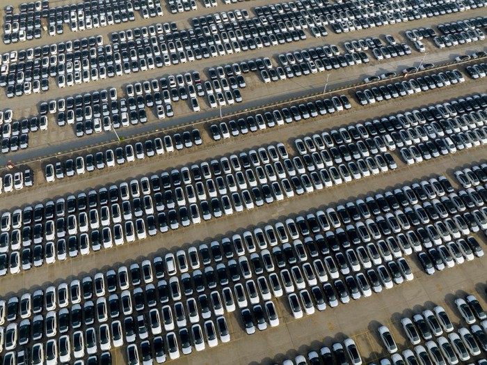 XIANGYANG, CHINA - JUNE 13: Aerial view of new Nissan vehicles sit parked at a parking lot of Xiangyang Fengshen Logistics Co. Ltd next to the Dongfeng Nissan Passenger Vehicle Company on June 13, 2022 in Xiangyang, Hubei Province of China. (Photo by VCG/VCG via Getty Images)