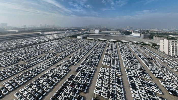 XIANGYANG, CHINA - JUNE 13: Aerial view of new Nissan vehicles sit parked at a parking lot of Xiangyang Fengshen Logistics Co. Ltd next to the Dongfeng Nissan Passenger Vehicle Company on June 13, 2022 in Xiangyang, Hubei Province of China. (Photo by VCG/VCG via Getty Images)