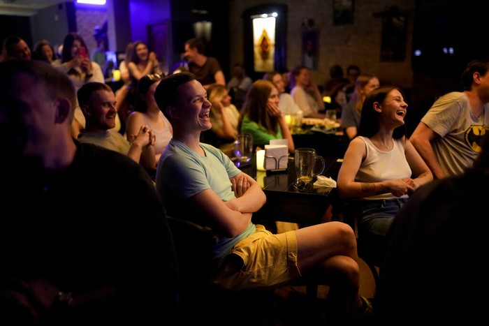 People attend Serhiy Lipkos stand-up comedy show in Kyiv, Ukraine, Saturday, June 11, 2022. The war in Ukraine isnt remotely funny, but Ukrainians are learning to laugh about the awfulness of it all. Not necessarily because they want to, but because they have to stay sane in the conflict that has killed tens of thousands and is turning Ukraine, millions of lives, and the world order inside out. (AP Photo/Natacha Pisarenko)