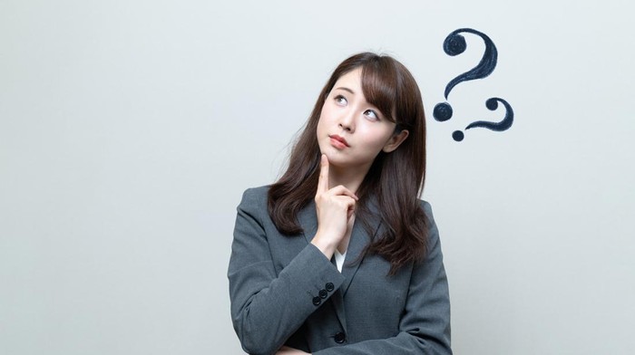 Young businesswoman having questions.