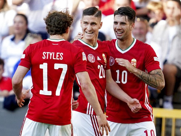 Hungary's Roland Sallai, center is congratulated after scoring the opening goal during the UEFA Nations League soccer match between England and Hungary at the Molineux stadium in Wolverhampton, England, Tuesday, June 14, 2022. (AP Photo/Jon Super)
