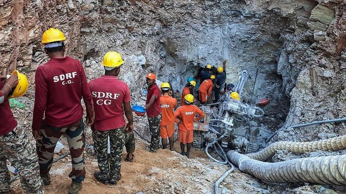 Rescue workers try to reach a 10-year-old boy who got trapped in a narrow well in the backyard of his house in the Piharid village in Janjgir’s Champa district of India’s Chattisgarh state. - AFP PIC