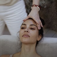 Setelah wajahnya bebas dari makeup, Kim Kardashian berbaring di sofa untuk mendapatkan perawatan wajah dari ahli kecantikan Joanna Czech. Sang ahli akan mengaplikasikan produk skincare Kim untuk memperlihatkan pada penonton YouTube khasiat dari SKKN BY KIM. Foto: Dok. YouTube SKKN BY KIM