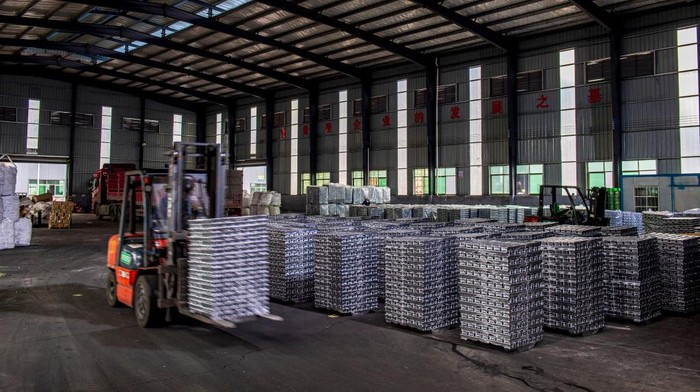 SHAOYANG, CHINA - DECEMBER 16: A worker operates a forklift to transport aluminium bars at an aluminum recycling plant in Quetang Circular Economy Industrial Park on December 16, 2021 in Shaoyang, Hunan Province of China. (Photo by VCG/VCG via Getty Images)