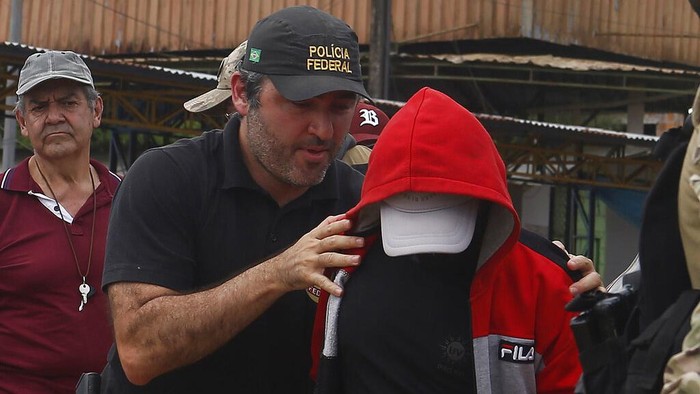 Federal police officers arrive at the pier with recovered human remains found during a search for Indigenous expert Bruno Pereira of Brazil and freelance reporter Dom Phillips of Britain, in Atalaia do Norte, Amazonas state, Brazil, Wednesday, June 15, 2022. A federal police investigator said a suspect confessed to fatally shooting Pereira and Phillips in a remote part of the Amazon and took officers to where the bodies were buried. (AP Photo/Edmar Barros)