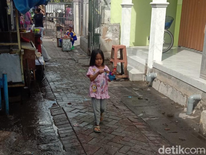 Banjir rob melanda kawasan Krembangan Surabaya. Di jalan, lalu lintas tersendat. Di permukiman, banyak anak-anak bermain air banjir.