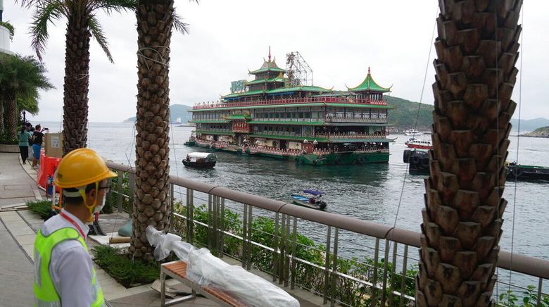 Hong Kongs iconic Jumbo Floating Restaurant is towed away in Hong Kong, Tuesday, June 14, 2022. Hong Kongs iconic restaurant on Tuesday departed the city, after its parent company failed to find a new owner and lacked funds to maintain the establishment amid months of COVID-19 restrictions. (AP Photo/Kin Cheung)