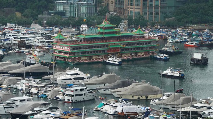 Hong Kong's iconic Jumbo Floating Restaurant is towed away in Hong Kong, Tuesday, June 14, 2022. Hong Kong's iconic restaurant on Tuesday departed the city, after its parent company failed to find a new owner and lacked funds to maintain the establishment amid months of COVID-19 restrictions. (AP Photo/Kin Cheung)
