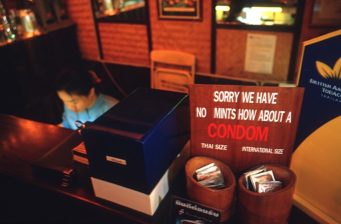 158608233 BANGKOK, THAILAND - 1994/02/01: A portrait of Mechai Viravaidya who is Thailand's leading anti AIDS activist sitting in the restaurant he founded called 'Cabbages and Condoms. Here he takes an 'after-dinner condom' instead of a mint! He has popularised condom use in Thailand and has created popular family planning clinics in the country. Such is his fame that condoms in Thailand are now known as 'Mechais'.. (Photo by Peter Charlesworth/LightRocket via Getty Images)