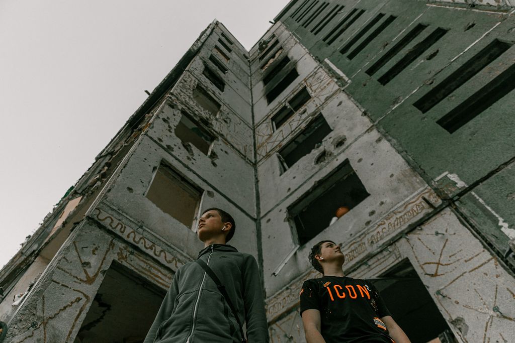 Students pose next to a damaged building for a high school graduation photoshoot, as Russia's attack on Ukraine continues, in Chernihiv, Ukraine, June 5, 2022. Picture taken on June 5, 2022. Instagram/@senykstas/Handout via REUTERS  THIS IMAGE HAS BEEN SUPPLIED BY A THIRD PARTY. MANDATORY CREDIT. NO RESALES. NO ARCHIVES.