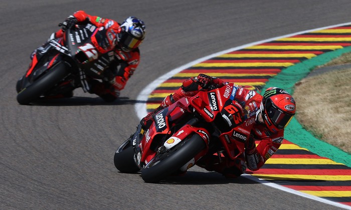 Ducati Lenovo Team Italian rider Francesco Bagnaia (R) and Aprilia Spanish rider Maverick Vinales steer their motorbikes during the qualifying session of the MotoGP German motorcycle Grand Prix at the Sachsenring racing circuit in Hohenstein-Ernstthal near Chemnitz, eastern Germany, on June 18, 2022. (Photo by Ronny Hartmann / AFP) (Photo by RONNY HARTMANN/AFP via Getty Images)