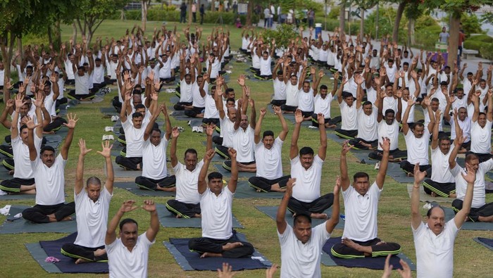 India's paramilitary Rapid Action Force personnel and their family members practise yoga on the eve of International Yoga Day in Ahmedabad, India, Monday, June 20, 2022. (AP Photo/Ajit Solanki)