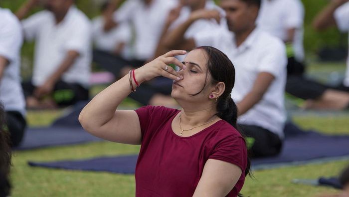 Indias paramilitary Rapid Action Force personnel and their family members practise yoga on the eve of International Yoga Day in Ahmedabad, India, Monday, June 20, 2022. (AP Photo/Ajit Solanki)