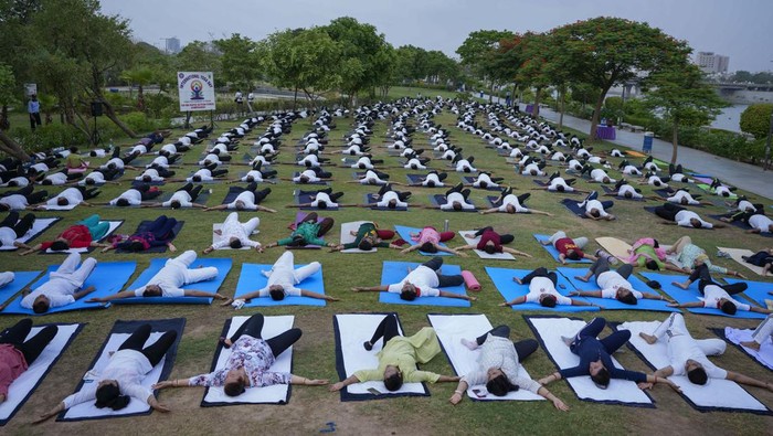India's paramilitary Rapid Action Force personnel and their family members practise yoga on the eve of International Yoga Day in Ahmedabad, India, Monday, June 20, 2022. (AP Photo/Ajit Solanki)