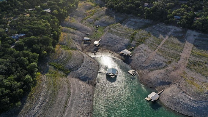 Residential boat docks sit on dry land at Medina Lake outside of San Antonio as majority of Texas experiences drought amid an extreme heat wave hitting the state, in Medina County, Texas, U.S., June 18, 2022. Picture taken June 18, 2022. REUTERS/Jordan Vonderhaar