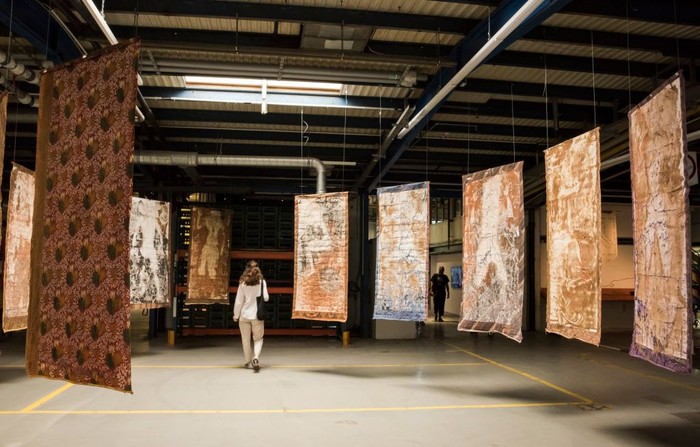 A professional visitor looks at a work by the 