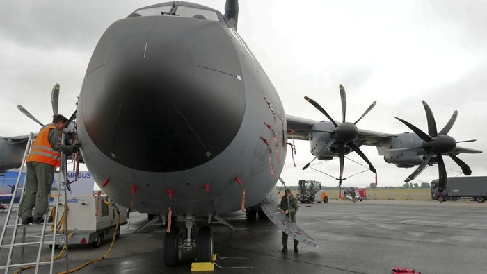 A member of the staff works on an A400 M airplane during the ILA Berlin Air Show in Schoenefeld near Berlin, Germany, Monday, June 20, 2022. The Berlin Air Show takes place from June 22 until June 26, 2022 at the Berlin ExpoCenter Airport fairground close to the airport Berlin Brandenburg (BER). (AP Photo/Michael Sohn)