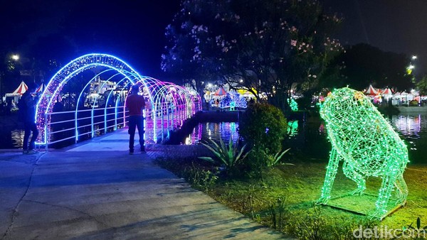 Indahnya guratan cahaya warna-warni di PRJ membuat para pengunjung asyik ber-swafoto di jembatan tersebut.