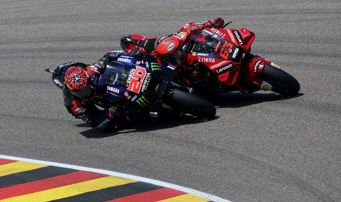 Monster Energy Yamahas French rider Fabio Quartararo (L) and Ducati Lenovo Team Italian rider Francesco Bagnaia compete during the German MotoGP Grand Prix at the Sachsenring racing circuit in Hohenstein-Ernstthal near Chemnitz, eastern Germany, on June 19, 2022. (Photo by Ronny Hartmann / AFP) (Photo by RONNY HARTMANN/AFP via Getty Images)