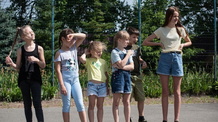 KYIV, UKRAINE - JUNE 20: Children participate in an outside activity on June 20, 2022 near Kyiv, Ukraine. The goal of the 7fields camp, which is near Zalissia National Nature Park, is to support the children of families displaced from other parts of Ukraine since the February 24 invasion, but who are remaining in the country. Over the summer, the camp aims to support 300 children between the ages of 7 and 15, with activities like swimming pools, tennis, soccer, yoga, chess and craft-making, in addition to therapy sessions. (Photo by Alexey Furman/Getty Images)