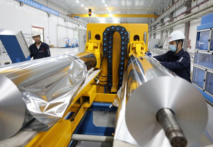 HUAIBEI, CHINA - OCTOBER 17: An employee works on the production line of aluminum foil at a factory on October 17, 2021 in Huaibei, Anhui Province of China. (Photo by Li Xin/VCG via Getty Images)