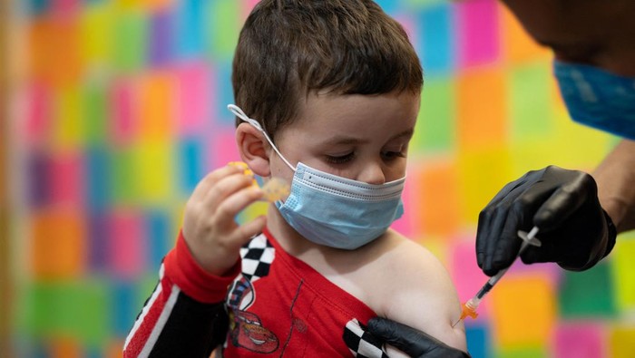 Balita di AS Mulai Terima Suntikan Vaksin Covid-19 Jade O'Brien, 4, receives the Moderna coronavirus disease (COVID-19) vaccine at Skippack Pharmacy in Schwenksville, Pennsylvania, U.S., June 20, 2022. REUTERS/Hannah Beier