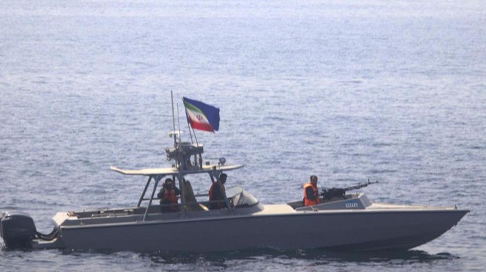 In this photo made available by the U.S. Navy, a boat of Irans Islamic Revolutionary Guard Corps Navy (IRGCN) operates in close proximity to patrol coastal ship USS Sirocco (PC 6) and expeditionary fast transport USNS Choctaw County (T-EPF 2) in the Strait of Hormuz, Monday, June 20, 2022. A U.S. Navy warship fired a warning flare to wave off an Iranian Revolutionary Guard speedboat coming straight at it during a tense encounter in the strategic Strait of Hormuz, officials said Tuesday. (U.S. Navy via AP)