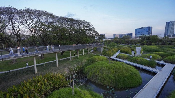 Peoples ride bicycles at Benjakitti Park in Bangkok, Thailand, Friday, April 1, 2022. Bursting with trees, ponds, plants and birdlife, the new inner-city park is delighting residents of Thailand’s bustling, congested capital. Every day, crowds visit Benjakitti Forest Park to savor a taste of nature in the heart of Bangkok. (AP Photo/Sakchai Lalit)