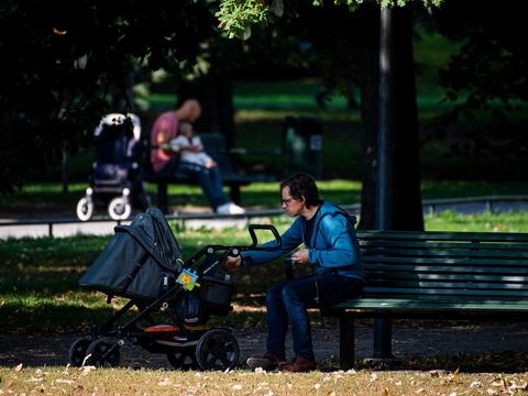 Two men take care of their babies at Humlegarden in Stockholm on September 24, 2020. - While France has just increased paternity leave to 28 days, in Sweden, a pioneer in gender equality, parents share 480 days off, which can be taken until the child's 12th birthday at 80% of the salary for the first 390 days and fathers have a minimum of three months, but only half of them take full advantage of it. (Photo by Jonathan NACKSTRAND / AFP) (Photo by JONATHAN NACKSTRAND/AFP via Getty Images)