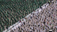 Sementara peserta membentuk mosaik dengan mengenakan pakaian berwarna hijau, putih dan merah, warna bendera Meksiko.