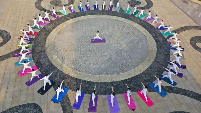 TOPSHOT - This aerial photo shows people practising yoga at a park in Handan in Chinas northern Hebei province on June 20, 2022, ahead of International Yoga Day on June 21. - China OUT (Photo by AFP) / China OUT (Photo by STR/AFP via Getty Images)