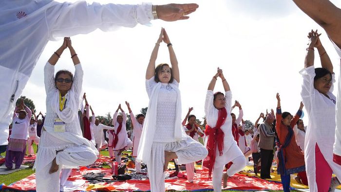 People perform yoga to mark International Day of Yoga in Kathmandu, Nepal, Tuesday, June 21, 2022. (AP Photo/Niranjan Shrestha)