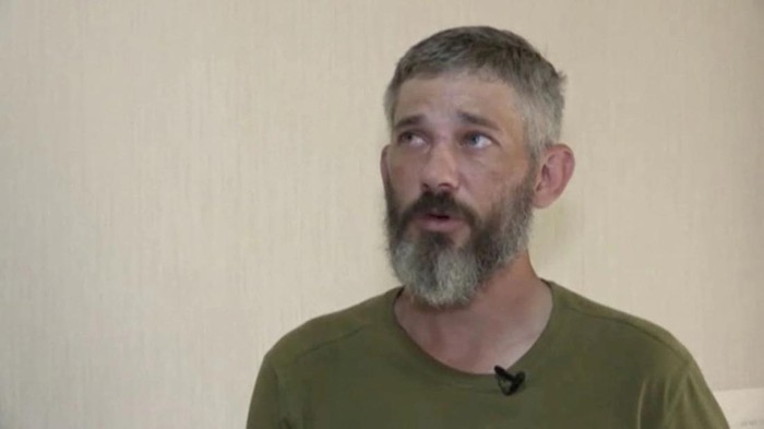 A still image taken from Russian state TV footage that it said shows Alexander Drueke, a U.S. citizen captured by Russian forces while fighting for Ukraine, at an unknown location, in a still image from a video released on June 17, 2022. Video released June 17, 2022. RU-RTR/Handout via REUTERS TV