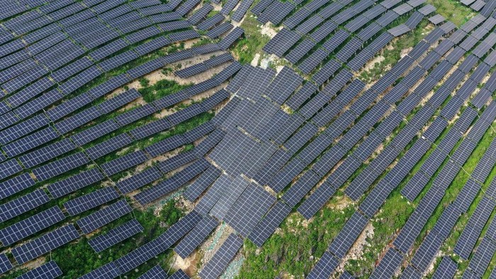 1241432735 ANLONG, CHINA - JUNE 21, 2022 - An aerial photo taken on June 21, 2022 shows a photovoltaic power station in Xinjie Village, Puping Town, Anlong County, Buyi and Miao Autonomous Prefecture of Qiannan, Southwest China's Guizhou Province. In recent years, Guizhou province has taken advantage of barren hillsides to develop photovoltaic power stations and promote the construction of green and clean energy. (Photo credit should read CFOTO/Future Publishing via Getty Images)