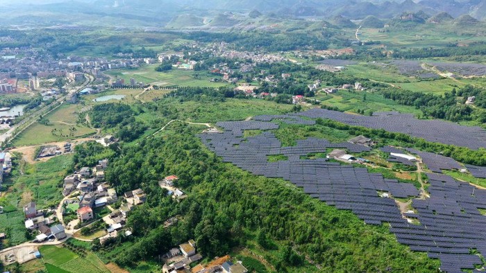 1241432735 ANLONG, CHINA - JUNE 21, 2022 - An aerial photo taken on June 21, 2022 shows a photovoltaic power station in Xinjie Village, Puping Town, Anlong County, Buyi and Miao Autonomous Prefecture of Qiannan, Southwest China's Guizhou Province. In recent years, Guizhou province has taken advantage of barren hillsides to develop photovoltaic power stations and promote the construction of green and clean energy. (Photo credit should read CFOTO/Future Publishing via Getty Images)