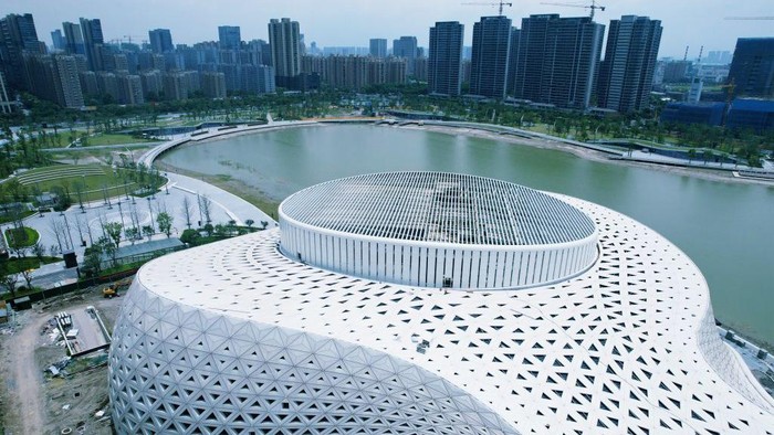 HANGZHOU, CHINA - JUNE 22, 2022 - An aerial view of the completed facade of the Hangzhou Jinsha Lake Grand Theater in Hangzhou, East China's Zhejiang Province, on June 22, 2022. With a total construction area of about 44,000 square meters, Hangzhou Jinsha Lake Grand Theater is divided into two areas, 1400 theater halls and 500 multi-function halls, which are connected by a shared hall. The theatre will become the most important cultural landmark in the eastern part of Hangzhou. (Photo credit should read CFOTO/Future Publishing via Getty Images)