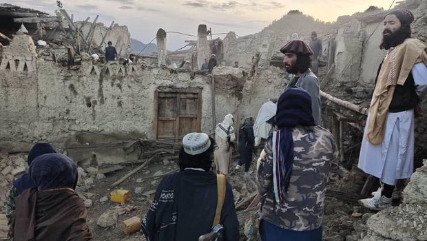 In this photo released by a set-run news agency Bakhtar, Afghans look at destruction caused by an earthquake in the province of Paktika, eastern Afghanistan, Wednesday, June 22, 2022. (Bakhtar News Agency via AP)