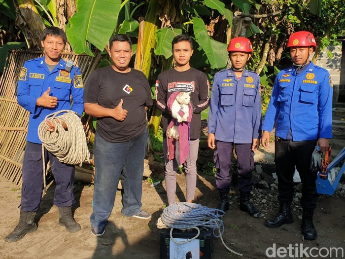 Petugas damkar usai mengevakuasi kucing milik Yones Auri di Blitar