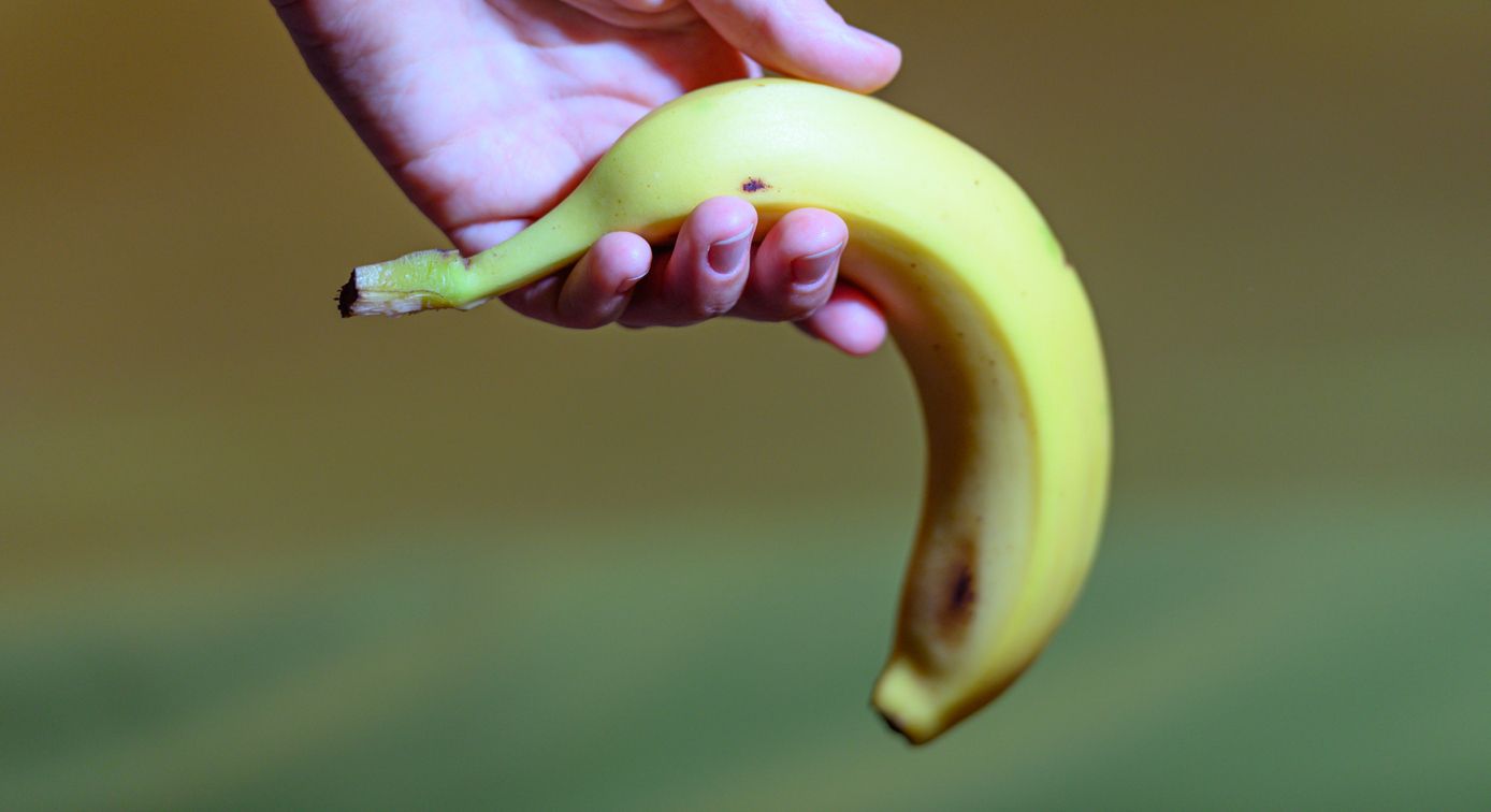Hand holding banana as a symbol of sexual dysfunction