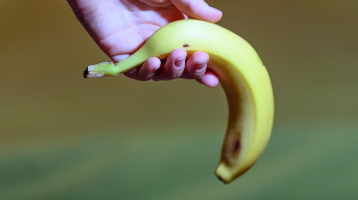 Hand holding banana as a symbol of sexual dysfunction