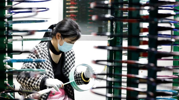 1394206671 SIHONG, CHINA - APRIL 28: An employee works on the production line of carbon fiber badminton rackets at a factory on April 28, 2022 in Sihong County, Suqian City, Jiangsu Province of China. (Photo by Xu Changliang/VCG via Getty Images)