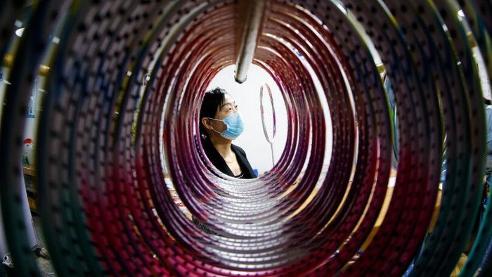 1394206671 SIHONG, CHINA - APRIL 28: An employee works on the production line of carbon fiber badminton rackets at a factory on April 28, 2022 in Sihong County, Suqian City, Jiangsu Province of China. (Photo by Xu Changliang/VCG via Getty Images)