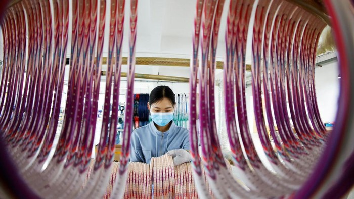 1394206671 SIHONG, CHINA - APRIL 28: An employee works on the production line of carbon fiber badminton rackets at a factory on April 28, 2022 in Sihong County, Suqian City, Jiangsu Province of China. (Photo by Xu Changliang/VCG via Getty Images)