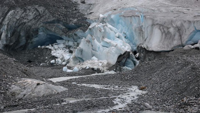 ZERMATT, SWITZERLAND - JUNE 21: The receding Lower Theodul glacier descends from the Breithorn plateau on the Swiss/Italian border on June 21, 2022 near Zermatt, Switzerland. This summer is likely to be especially brutal for Switzerland’s glaciers. Normally in mid-June glaciers would still be covered in snow that protects them from the sun, though because very little snow fell this year, the glaciers are already exposed and melting rapidly under conditions that are more typical for late July or August. Matthias Huss, a glaciologist with ETH Zurich university and head of the Swiss glacier monitoring network, and his colleagues are studying approximately 20 glaciers across Switzerland, including several around Zermatt, to observe the effects of global warming. All of the glaciers are melting, and he predicts that if we do not meet global climate goals Switzerland’s glaciers will be mostly gone by 2100.  (Photo by Sean Gallup/Getty Images)