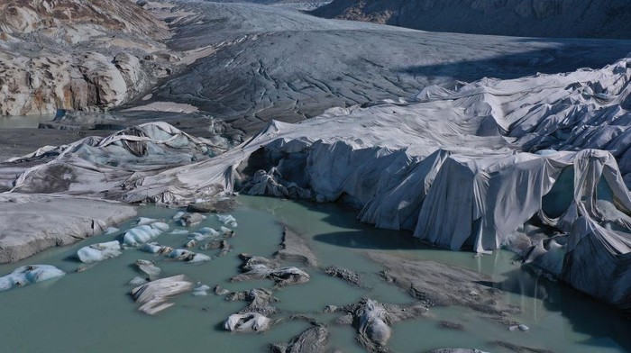 1404535420 ZERMATT, SWITZERLAND - JUNE 21: The receding Lower Theodul glacier descends from the Breithorn plateau on the Swiss/Italian border on June 21, 2022 near Zermatt, Switzerland. This summer is likely to be especially brutal for Switzerlandβs glaciers. Normally in mid-June glaciers would still be covered in snow that protects them from the sun, though because very little snow fell this year, the glaciers are already exposed and melting rapidly under conditions that are more typical for late July or August. Matthias Huss, a glaciologist with ETH Zurich university and head of the Swiss glacier monitoring network, and his colleagues are studying approximately 20 glaciers across Switzerland, including several around Zermatt, to observe the effects of global warming. All of the glaciers are melting, and he predicts that if we do not meet global climate goals Switzerlandβs glaciers will be mostly gone by 2100. (Photo by Sean Gallup/Getty Images)