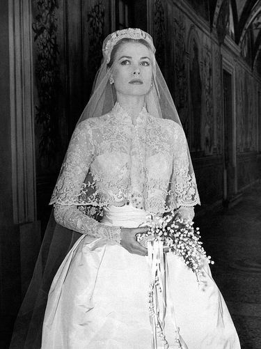 The big movie star Grace Kelly photographed in her bridal dress in a frescoed gallery within the Prince's Palace, just before the wedding ceremony where she will marry Ranier III of Monaco, becoming princess of the Principality. Monaco, April 18th, 1956. (Photo by Mondadori via Getty Images)
