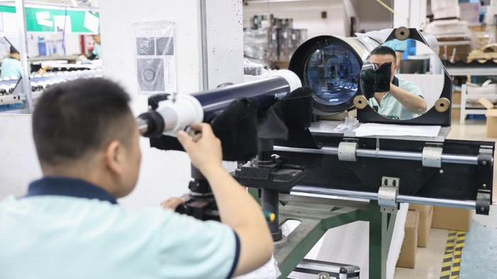 RUGAO, CHINA - JUNE 23, 2022 - Workers assemble an astronomical telescope at an assembly workshop of Nantong Smitsen Photoelectric Technology Co., LTD in Rugao, Jiangsu Province, June 23, 2022. The products are exported to more than 100 countries and regions such as the United States, Canada, The United Kingdom, France, Germany, Italy and so on. The brand telescopes produced by the company are widely welcomed by foreign consumers. At present, the products have occupied more than 80% market share in the global middle and high-end market. (Photo credit should read CFOTO/Future Publishing via Getty Images)
