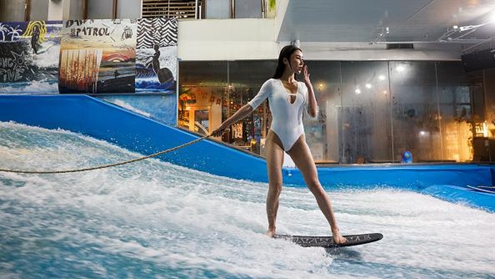 BEIJING, CHINA - JUNE 22: A man practices surfing in a Surfing Club on June 22, 2022 in Beijing, China. All sports and fitness facilities in Beijing have reopened to the public at 75 percent customer capacity. (Photo by Fred Lee/Getty Images)